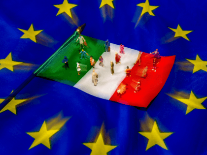 A picture taken on May 30, 2018 shows figurines on an Italian flag lying on a European Union flag. - Italy, one of the European Union's biggest economies, has been plunged into crisis after President Sergio Mattarella at the weekend vetoed the new government's nomination of a fierce eurosceptic as …