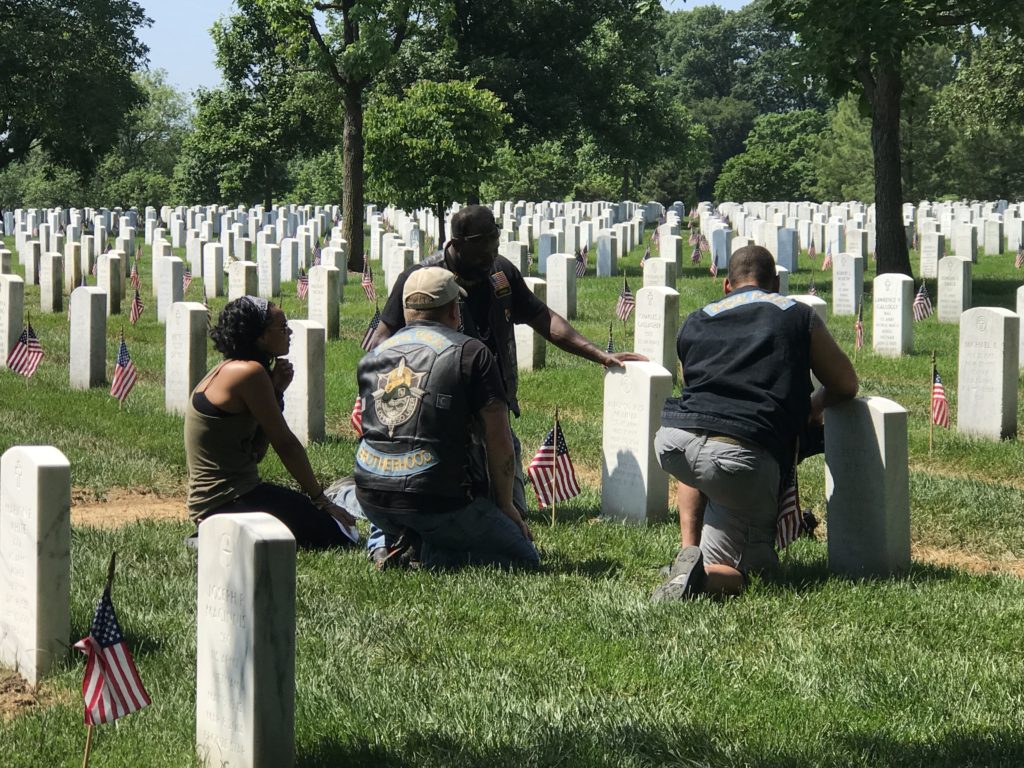 Jaraan Little sits at Molinar’s gravestone sharing memories along with others who knew him. Photo: Kristina Wong/Breitbart News