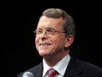 MIke DeWine-smile-getty U.S. Sen. Mike DeWine (R - Ohio) smiles while looking at a T.V. camera before facing off October 19, 2006, against challenger U.S. Rep. Sherrod Brown (D - Ohio) before a live Televised debate at the Stranahan Theater in Toledo, Ohio. (Photo by J.D. Pooley/Getty Images)
