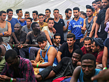 Migrants wait to reach the Italian coast on the deck of the Spanish NGO ProActiva Open Arm