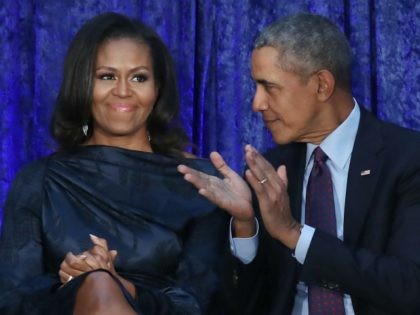 Former U.S. President Barack Obama and first lady Michelle Obama participate in the unveiling of their official portraits during a ceremony at the Smithsonian’s National Portrait Gallery, on February 12, 2018 in Washington, DC. The portraits were commissioned by the Gallery, for Kehinde Wiley to create President Obama’s portrait, and …