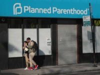 Planned-Parenthood-boy-and-girl-hugging-walking-getty Pedestrians walk past a Planned Parenthood clinic on May 18, 2018 in Chicago, Illinois. The Trump administration is expected to announce a plan for massive funding cuts to Planned Parenthood and other taxpayer-backed abortion providers by reinstating a Reagan-era rule that prohibits federal funding from going to clinics that discuss …