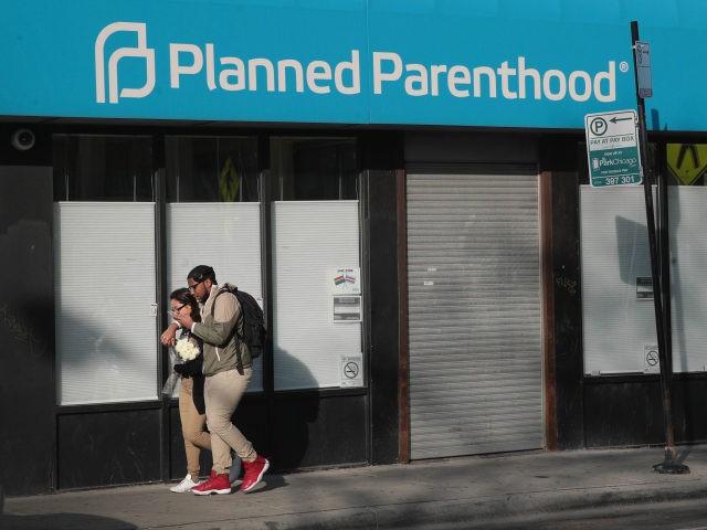 Pedestrians walk past a Planned Parenthood clinic on May 18, 2018 in Chicago, Illinois. The Trump administration is expected to announce a plan for massive funding cuts to Planned Parenthood and other taxpayer-backed abortion providers by reinstating a Reagan-era rule that prohibits federal funding from going to clinics that discuss …