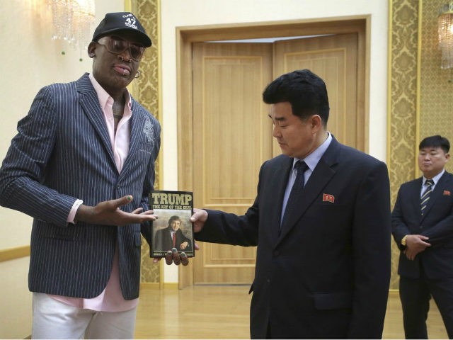 Former NBA basketball star Dennis Rodman presents a book titled "Trump The Art of the Deal" to North Korea's Sports Minister Kim Il Guk Thursday, June 15, 2017, in Pyongyang, North Korea. (AP Photo/Kim Kwang Hyon)