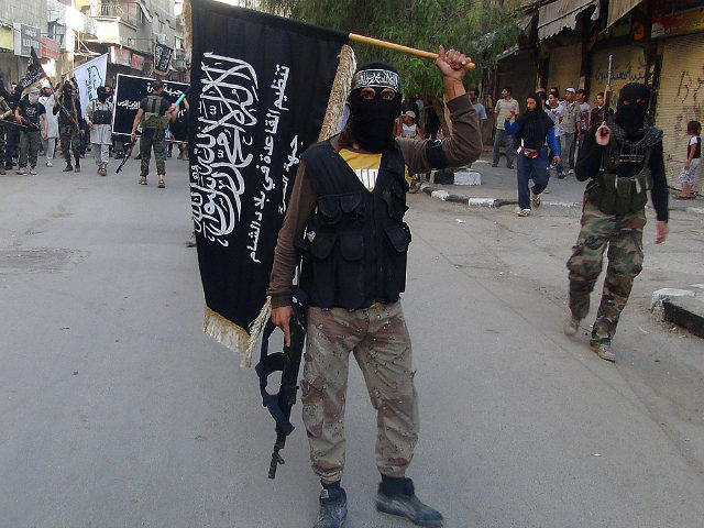 Islamic fighters from the al-Qaida group in the Levant, Al-Nusra Front, wave their movement's flag as they parade at the Yarmuk Palestinian refugee camp, south of Damascus, to denounce Israels military offensive on the Gaza Strip, on July 28, 2014. Israeli shells struck a UN school in Gaza early today, …