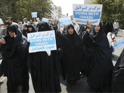 Iranian women hold anti-Israeli placards at a protest after Friday prayer service in Tehran, Iran, Friday, Sept. 18, 2015. Hundreds of worshipers staged an anti-Israeli protest for its response to Palestinians protest against unusual numbers of Jewish visitors at Al-Aqsa mosque compound in recent days. Chanting “Death to Israel” and …