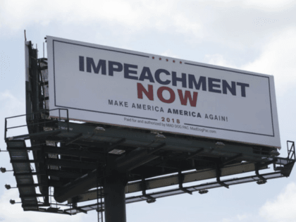 WEST PALM BEACH, FL - MARCH 19: A billboard reading: 'Impeachment Now Make America America Again!' calling for President Donald Trump's impeachment is seen along a street leading to Mar-A-Lago on March 19, 2018 in West Palm Beach, Florida. The sign was installed by The Mad Dog PAC and is …