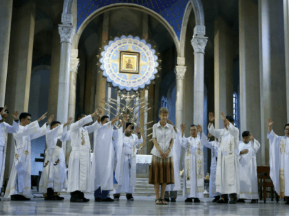 Australian Catholic nun Sister Patricia Fox is prayed over by Roman Catholic priests durin