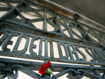 A flower sticks next to the writing 'Jedem das Seine' (literally: To each his own) at the gate of the Buchenwald concentration camp in Weimar, where ceremonies were held 15 April 2007 to mark the 62nd anniversary of the camp's liberation. US army units liberated 21,000 survivors here on 11 …