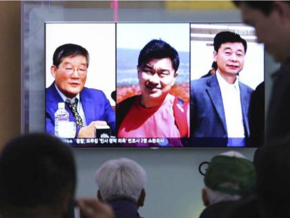 In this May 3, 2018, photo, people watch a TV news report on screen showing portraits of three Americans, Kim Dong Chul, left, Tony Kim and Kim Hak Song, right, detained in the North Korea, at the Seoul Railway Station in Seoul, South Korea. (Ahn Young-joon / AP)