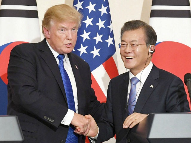 U.S. President Donald Trump (L) and his South Korean counterpart Moon Jae In shake hands a