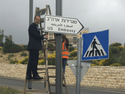 In this photo released by the Jerusalem Municipality, Jerusalem Mayor Nir Barkat poses with a new road sign to the new U.S. Embassy in Jerusalem, Monday, May 7, 2018. Jerusalem's city hall says it has put up road signs pointing to the new U.S. Embassy, which is set to move …