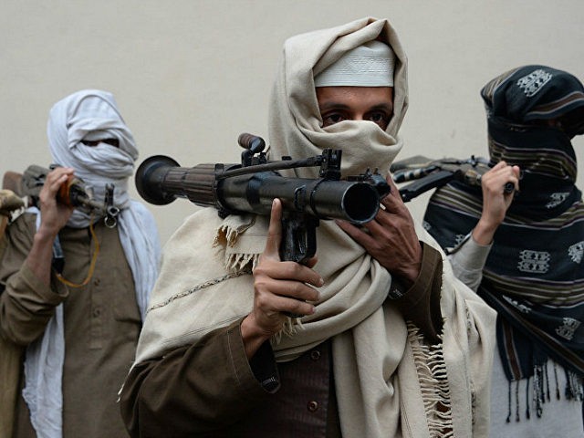 Former Afghan Taliban fighters carry their weapons before handing them over as part of a government peace and reconciliation process at a ceremony in Jalalabad on January 12, 2016. More than a dozen former Taliban fighters from Ghani district of Nangarhar province handed over their weapons as part of a …