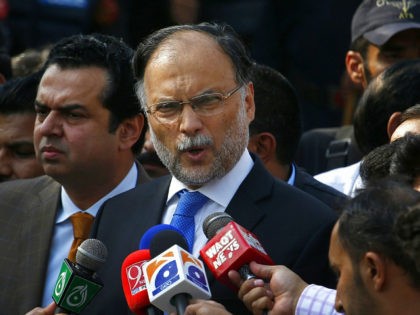 FILE - In this Oct. 2, 2017 file photo, Pakistani Interior Minister Ahsan Iqbal talks to journalists outside the accountability court, in Islamabad, Pakistan. Pakistani officials said Sunday, May 6, 2018, that a gunman opened fire on Iqbal after a public meeting, wounding him in shoulder. (AP Photo/Anjum Naveed, File)