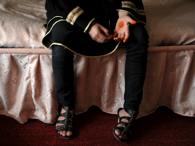This picture taken in Kabul on October 12, 2011 shows Afghan woman Nozari as she poses for