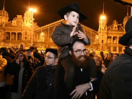 Hungarians from the Jewish community take part in a ceremony during which a giant Menorah is lit to mark the start of Hanukkah celebrations on December 12, 2017 at the Western square in the center of Budapest Hanukkah commemorates the re-dedication of the holy temple in Jerusalem after the Jews' …