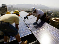 installing-solar-panels-roof-california-ap FILE - In this March 23, 2010, file photo, installers from California Green Design install solar electrical panels on the roof of a home in Glendale, Calif. The Obama administration is boosting the development of solar and wind energy on public lands. A final rule announced by the Interior Department …