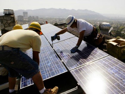 FILE - In this March 23, 2010, file photo, installers from California Green Design install solar electrical panels on the roof of a home in Glendale, Calif. The Obama administration is boosting the development of solar and wind energy on public lands. A final rule announced by the Interior Department …