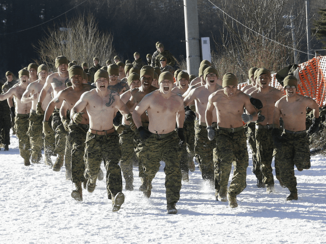 U.S. Marines from III-Marine Expeditionary Force from Okinawa, Japan, run on the snow to a