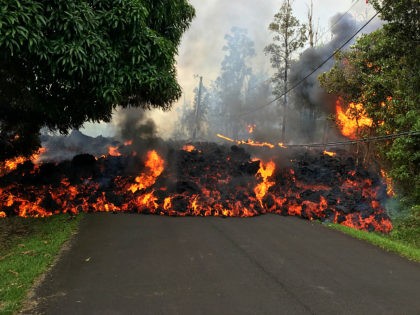 PAHOA, HI - MAY 6: In this handout photo provided by the U.S. Geological Survey, a lava flow moves on Makamae Street after the eruption of Hawaii's Kilauea volcano on May 6, 2018 in the Leilani Estates subdivision near Pahoa, Hawaii. The governor of Hawaii has declared a local state …