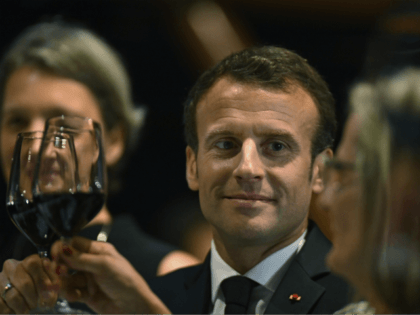 President of France, Emmanuel Macron, center, holds up his glass during a dinner hosted by Australian Prime Minister, Malcolm Turnbull, at the Sydney Opera House in Sydney, Tuesday, May 1, 2018. (Mick Tsikas/Pool Photo via AP)