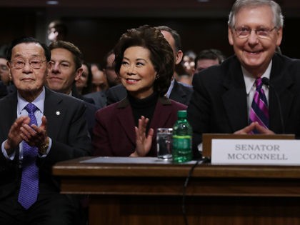 WASHINGTON, DC - JANUARY 11: Elaine Chao (C) listens to her husband Senate Majority Leader Mitch McConnell (R-KY) (R) during her confirmation hearing to be the next U.S. secretary of transportation before the Senate Commerce, Science and Transportation Committee in the Dirksen Senate Office Building on Capitol Hill January 11, …