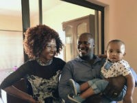 mom-dad-child-smiling-ap In this March 2017 photo provided by Bethany Christian Services Lena and Velie Mdushe (left and center) complete their adoption of a boy named Vuyani at the offices of Setshabelo Family and Child Services in Botshabelo, South Africa. The adoption program serving black South Africans _ a rarity in South …