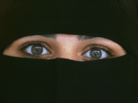 BLACKBURN, UNITED KINGDOM - OCTOBER 06: A Muslim woman wearing a Niqab poses inside an Asian fashion shop in the British northern town of Blackburn, the constituency of Member of Parliament Jack Straw, where a quarter of his constituents are Muslim on October 6, 2006, Blackburn, England. Leader of the …