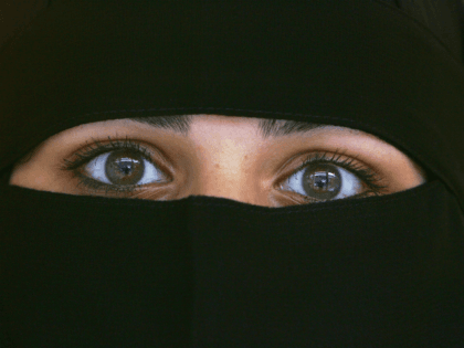 BLACKBURN, UNITED KINGDOM - OCTOBER 06: A Muslim woman wearing a Niqab poses inside an Asian fashion shop in the British northern town of Blackburn, the constituency of Member of Parliament Jack Straw, where a quarter of his constituents are Muslim on October 6, 2006, Blackburn, England. Leader of the …