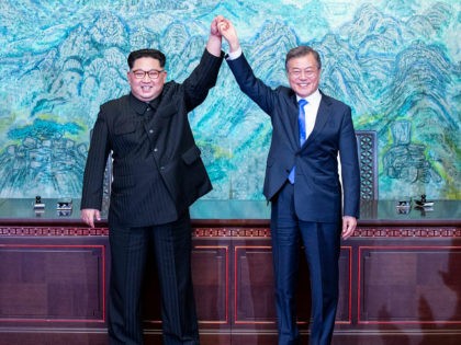 North Korean leader Kim Jong Un, left, and South Korean President Moon Jae-in raise their hands after signing on a joint statement at the border village of Panmunjom in the Demilitarized Zone, South Korea, Friday, April 27, 2018. (Korea Summit Press Pool via AP)