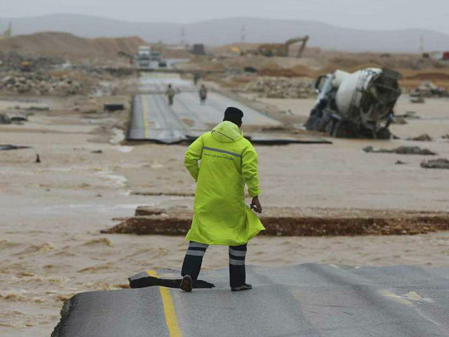 An Omani civil defence staff visits a road which has been cut by the flood water after Cyclone Merkunu in Salalah, Oman, Saturday, May 26, 2018. Cyclone Merkunu blew into the Arabian Peninsula on Saturday, drenching arid Oman and Yemen with rain, cutting off power lines and leaving at least …