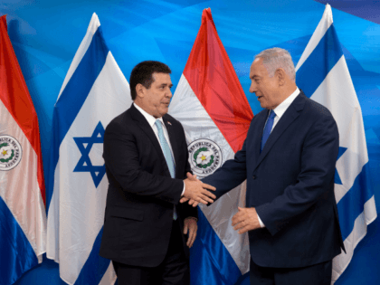 Israeli Prime Minister Benjamin Netanyahu (R) shakes hands with Paraguayan President Horacio Cartes during their meeting at the Prime Minister's office in Jerusalem on May 21, 2018. - Paraguay followed the US and Guatemala to inaugurate its new embassy in Jerusalem on May 21. (Photo by Sebastian Scheiner / POOL …