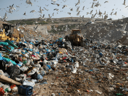 In this Wednesday, Feb. 2, 2018 file photo, earthmovers push mountains of garbage as seagulls fly over the country's largest landfill at Fyli on the outskirts of Athens. The British government is planning a consultation about a possible bill to end the use of plastic straws, drink stirrers and cotton …