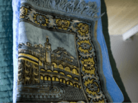 In this image reviewed by the U.S. Military, a traditional Muslim prayer rug sits folded next to slippers and flip flops, which are among the basic items provided to detainees, on a cot in Camp 4 medium-security detention facility on the U.S. Naval Base in Guantanamo Bay, Cuba, Tuesday, Nov. …