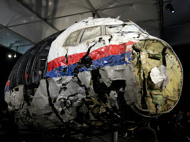 FILE - In this Tuesday, Oct. 13, 2015 file photo, the reconstructed wreckage of Malaysia Airlines Flight MH17 is put on display during a press conference in Gilze-Rijen, central Netherlands. Malaysia Airlines Flight 17 broke up high over Eastern Ukraine killing all 298 people on board. Any suspects in the …