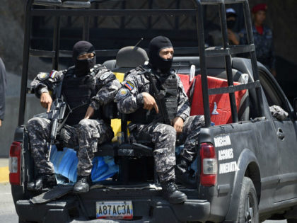 Security forces are seen at the entrance of El Helicoide, the headquarters of the Bolivari