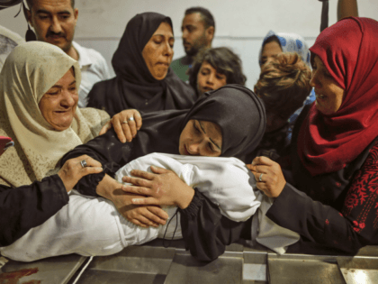 The mother of a Leila al-Ghandour (C), a Palestinian baby of 8 months who according to Gaza's health ministry died of tear gas inhalation during clashes in East Gaza the previous day, holds her at the morgue of al-Shifa hospital in Gaza City on May 15, 2018 - Fresh protests …