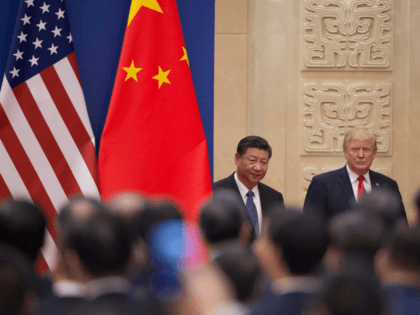 US President Donald Trump (R) and China's President Xi Jinping (L) arrive at a business leaders event inside the Great Hall of the People in Beijing on November 9, 2017. Donald Trump urged Chinese leader Xi Jinping to work 'hard' and act fast to help resolve the North Korean nuclear …