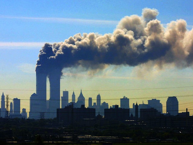 FILE - In this Sept. 11, 2001 file photo, as seen from the New Jersey Turnpike near Kearny, N.J., smoke billows from the twin towers of the World Trade Center in New York after airplanes crashed into both towers. Saudi Arabia and its allies are warning that legislation allowing the …