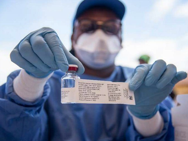 A nurse working with the World Health Organization (WHO) shows a bottle containing Ebola v