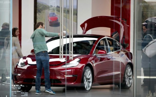 Tesla reports narrower than expected losses, shares rise