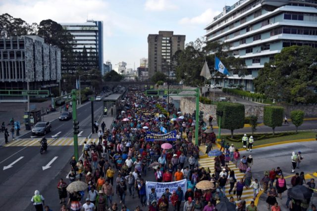 Guatemalan shop owners march in support of president