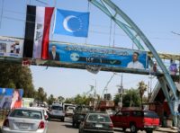 A picture taken on April 30, 2018, shows an electoral banner for the Iraqi Turkmen Front hanging beneath the flags of Iraq (L) and the Iraqi Turkmen (C) above a pedestrian crossing in the oil-rich and multi-ethnic northern city of Kirkuk A picture taken on April 30, 2018, shows an electoral banner for the Iraqi Turkmen Front hanging beneath the flags of Iraq (L) and the Iraqi Turkmen (C) above a pedestrian crossing in the oil-rich and multi-ethnic northern city of Kirkuk