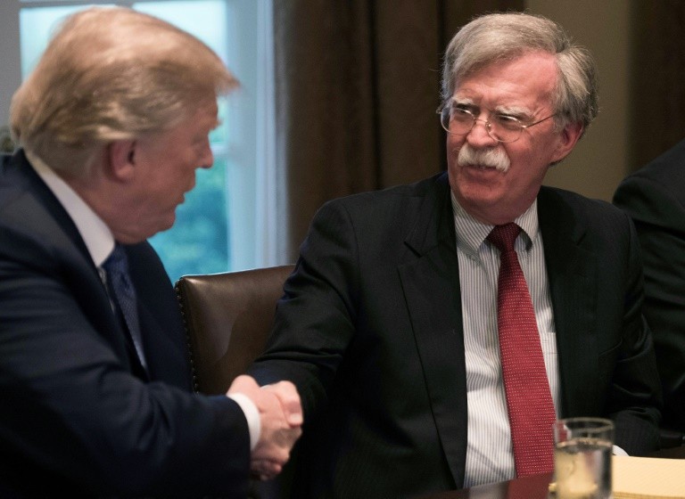US President Donald Trump, seen here shaking hands with National Security Advisor John Bolton, faces a May 12 deadline for deciding what, if anything, to do about the Iran nuclear deal