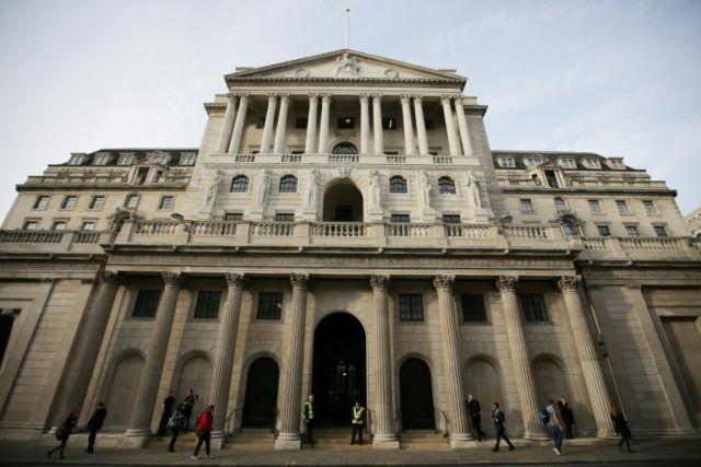 Bank of England holds rate, cuts growth forecast