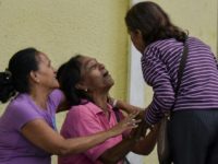 Relatives of inmates cry as they wait outside the Fenix Community Penitentiary in the town of Irribarren, where a riot left at least 11 people dead Prison riot in Venezuela leaves 11 dead, 28 wounded