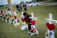 Jai Gillard, a freshman who was in the class where the mass shooting started, looks at a cross for Sabika Sheikh before signing it at a memorial for the victims of the Santa Fe High School shooting on May 21, 2018 Deadly Texas school shooting gunman 'confused,' his lawyers say