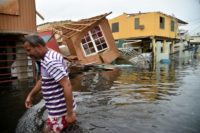 A man walks past destroyed homes in Catano, Puerto Rico, on September 21, 2017 in the wake of Hurricane Maria A man walks past destroyed homes in Catano, Puerto Rico, on September 21, 2017 in the wake of Hurricane Maria