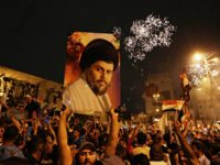 US Iraq In this May 14, 2018, file photo, followers of Shiite cleric Muqtada al Sadr, seen in the poster, celebrate in Tahrir Square, Baghdad, Iraq. Fourteen years after Muqtada al Sadr’s militias fought and killed American troops who had invaded Iraq, the United States is preparing to work hand in hand with the charismatic Shiite cleric and his movement. Following an upset Iraqi election, the U.S. is hoping to find common cause with al Sadr in curtailing Iran’s influence. (AP Photo/Hadi Mizban, File) The Associated Press