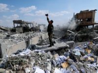 France Syria In this Saturday, April 14, 2018 file photo, a Syrian soldier films the damage of the Syrian Scientific Research Center which was attacked by U.S., British and French military strikes to punish President Bashar Assad for suspected chemical attack against civilians, in Barzeh, near Damascus, Syria. France's government is imposing new sanctions on people and companies suspected of helping Syria's chemical weapons program. (AP Photo/Hassan Ammar, File) The Associated Press